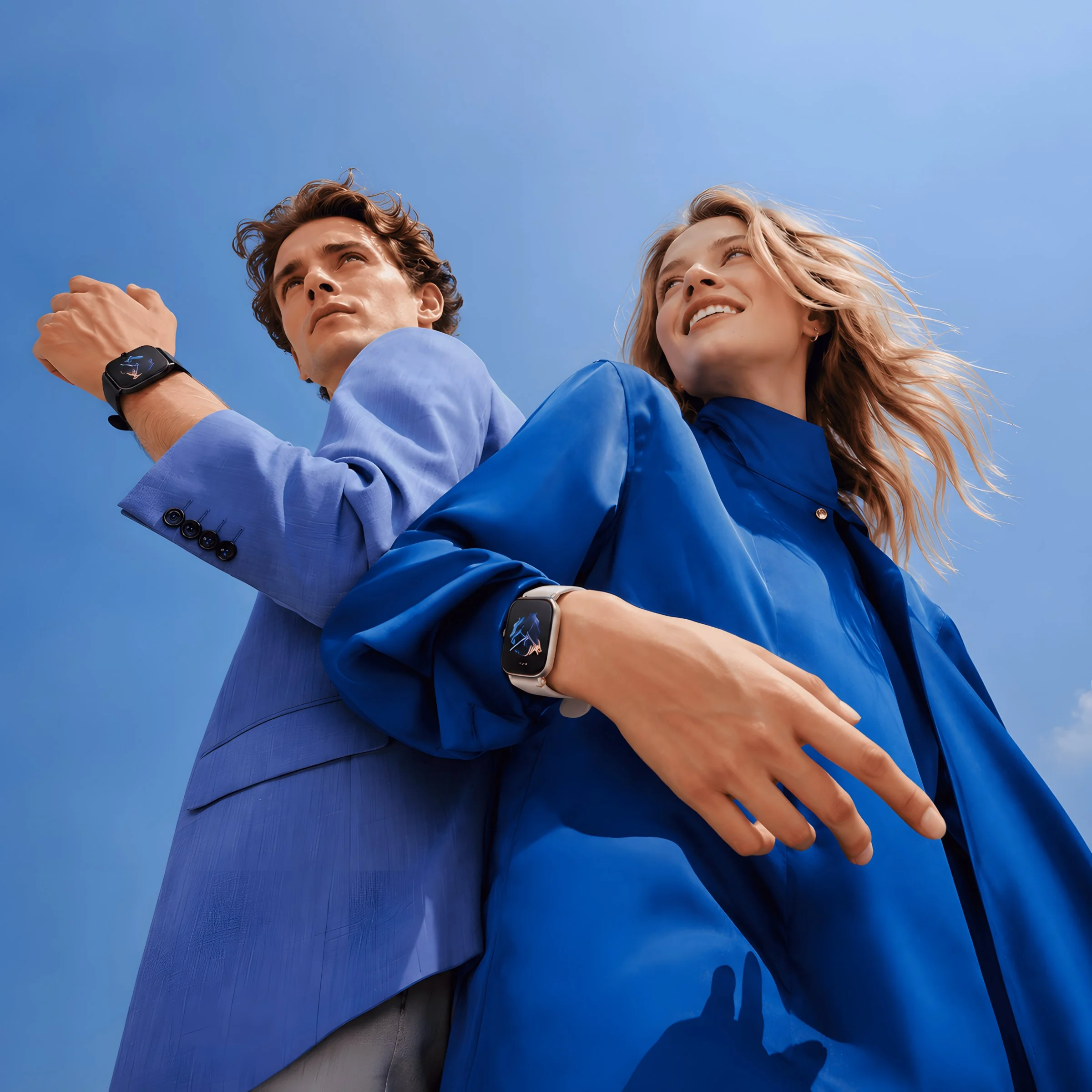 Two people looking upward against a clear blue sky